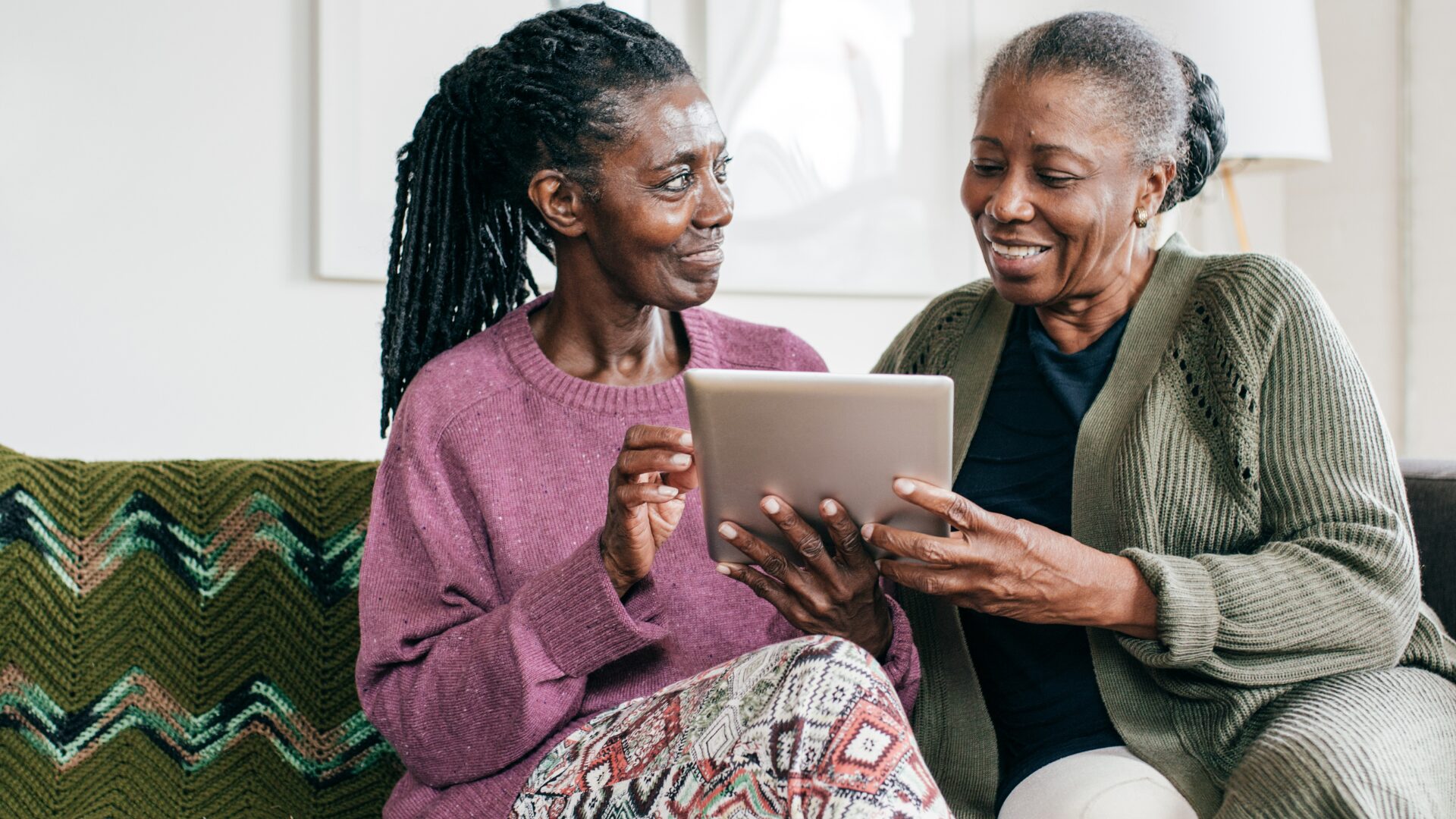 Two older women looking at a tablet