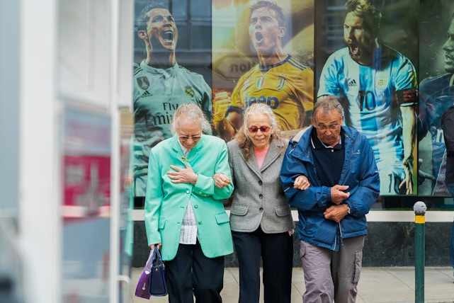 Elders walking arm-in-arm across the street