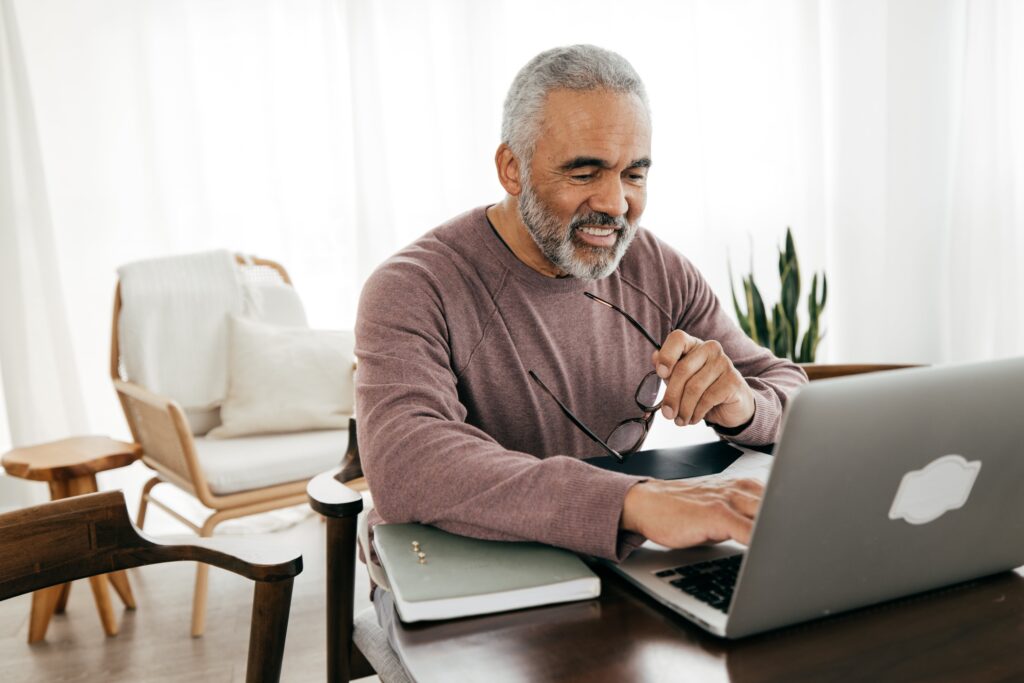 An older person using their laptop